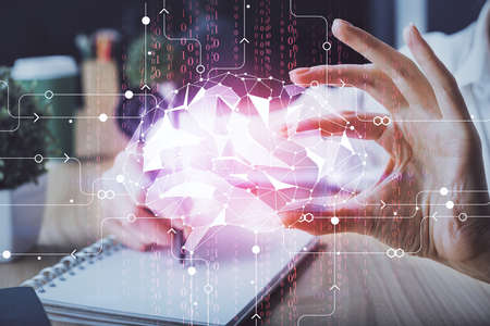 Multi exposure of writing hand on background with brain hologram. Concept of learning.
