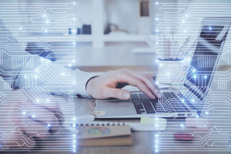 Technology theme hologram with man working on computer on background. High tech concept. Double exposure.の写真素材