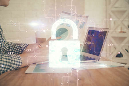 Double exposure of lock icon with man working on computer on background. Concept of network...