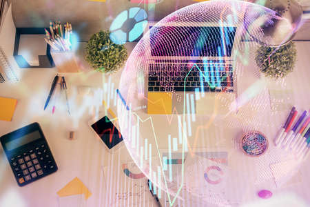 Double exposure of forex chart drawing over table background with computer. Concept of financial research and analysis. Top view.の写真素材