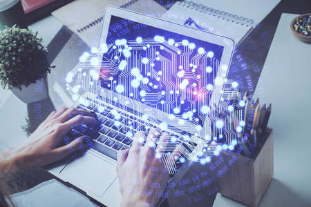Businessman with computer background with brain theme hologram. Concept of brainstorm. Multi...