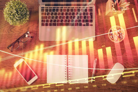 Stock market graph and top view computer on the table background. Multi exposure. Concept of...