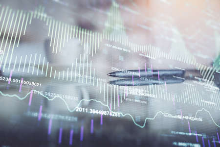 Double exposure of forex chart over coffee cup background in office. Concept of financial analysis...