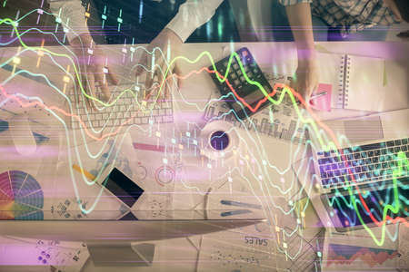 Double exposure of man and woman working together and financial chart hologram drawing. market...