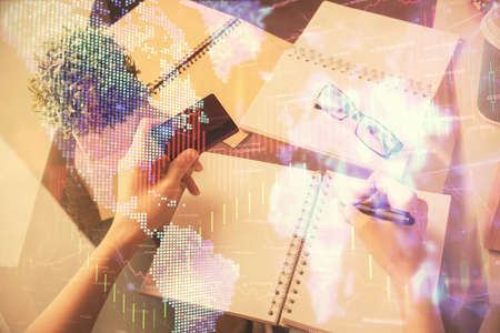 Multi exposure of woman on-line shopping holding a credit card and financial graph drawing. Stock...