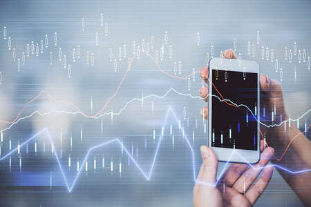Double exposure of forex graph sketch hologram and woman holding and using a mobile device. Stock...