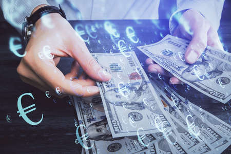 Multi exposure of financial graph drawing hologram and USA dollars bills and man hands. Analysis concept.の写真素材