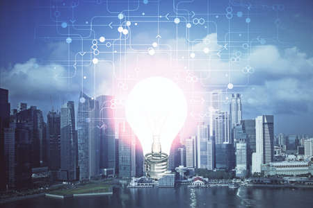 Multi exposure of bulb hologram drawing and cityscape background. Concept of idea.