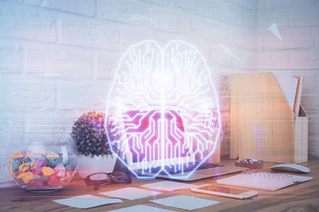 Double exposure of work space with computer and human brain drawing hologram. Brainstorm concept.
