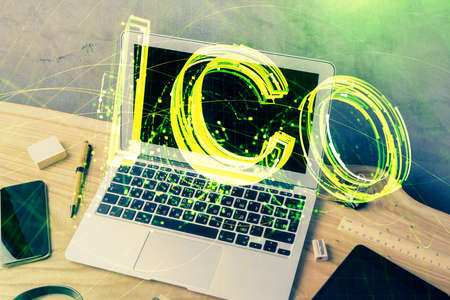 Double exposure of blockchain theme hologram and table with computer background. Concept of bitcoin crypto currency.の写真素材