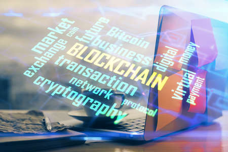Double exposure of blockchain theme hologram and table with computer background. Concept of bitcoin crypto currency.の写真素材