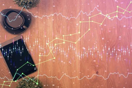 Multi exposure of financial chart hologram over desktop with phone. Top view. Mobile trade platform...