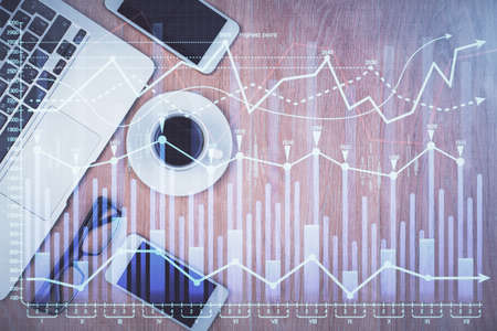 Multi exposure of financial chart hologram over desktop with phone. Top view. Mobile trade platform...