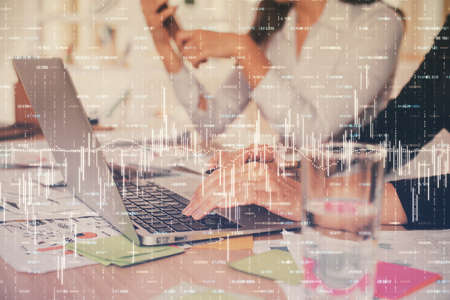 Multi exposure of woman hands typing on computer and forex chart hologram drawing. Stock market...