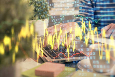 Double exposure of woman hands typing on computer and forex chart hologram drawing. Stock market...