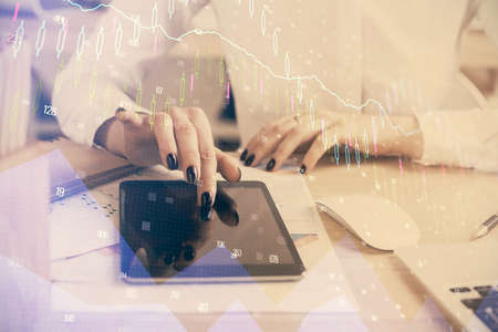 Double exposure of forex chart sketch hologram and woman holding and using a mobile device....
