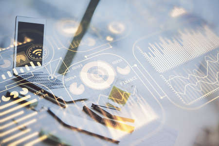 Computer on desktop in office with technology theme hologram. Double exposure. Tech concept.