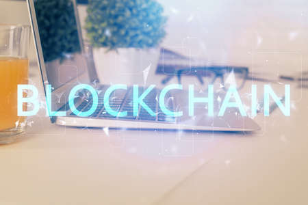 Double exposure of blockchain theme hologram and table with computer background. Concept of bitcoin...