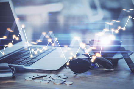 Financial market graph hologram and personal computer on background. Multi exposure. Concept of...