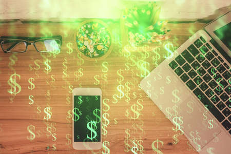 Double exposure of financial graph hologram over desktop with phone. Top view. Mobile trade platform concept.の写真素材