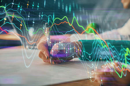 Double exposure of forex chart drawing over people taking notes background. Concept of financial...