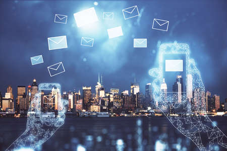 Double exposure of envelop hologram flying from gadget and city view background. Concept e-mail.の写真素材