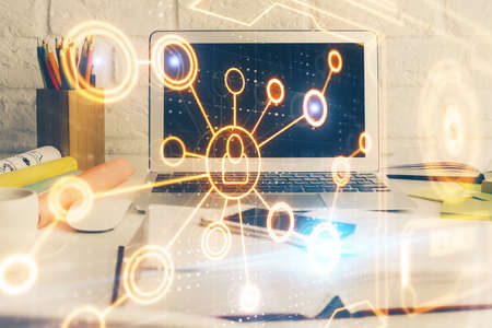 Computer on desktop with social network hologram. Multi exposure. Concept of international people...