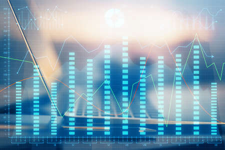 Financial chart drawing and table with computer on background. Double exposure. Concept of...
