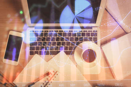 Stock market chart and top view computer on the table background. Double exposure. Concept of...