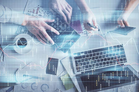 Double exposure of man and woman working together and financial chart hologram drawing. market...