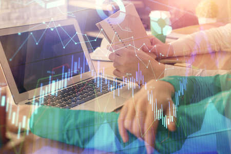Double exposure of man and woman working together and forex chart hologram. Business concept....