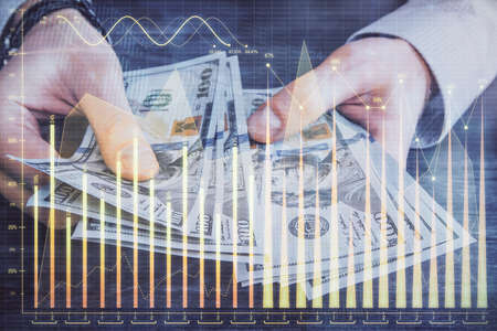 Multi exposure of financial graph drawing hologram and USA dollars bills and man hands. Analysis...