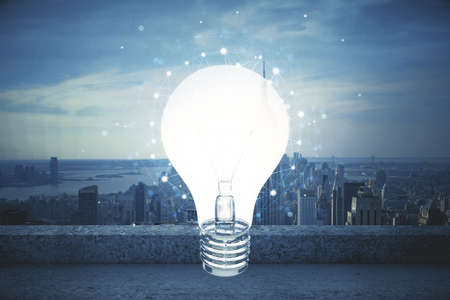 Multi exposure of bulb hologram drawing and cityscape background. Concept of idea.の写真素材