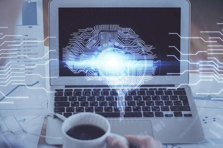 Multi exposure of work space with computer and human brain hologram. Brainstorm concept.