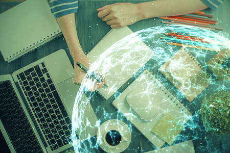 Social network theme hologram over woman's hands writing background. Concept of international people...