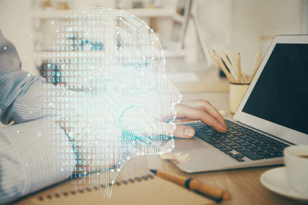 Man typing on keyboard background with brain hologram. Concept of big Data. Double exposure.