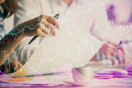 Double exposure of forex graph drawing over people taking notes background. Concept of financial...