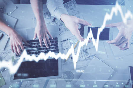 Multi exposure of man and woman working together and forex graph hologram drawing. Financial...