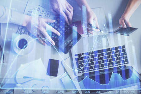 Double exposure of man and woman working together and financial chart hologram drawing. market...