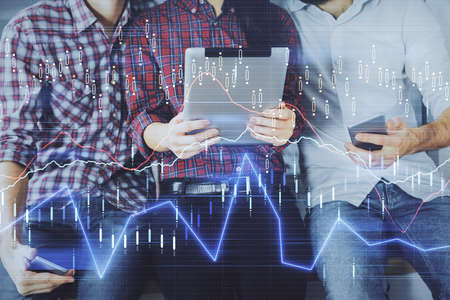 Double exposure of forex graph drawing and man and woman working together holding and using a mobile...