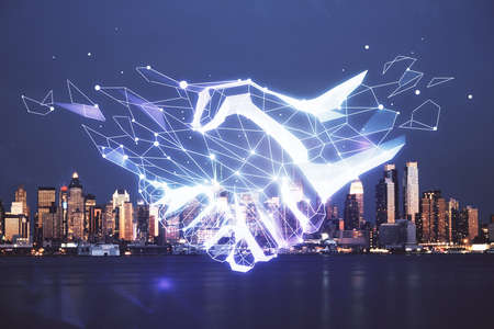 Double exposure of handshake hologram over city view background. Concept of partnership.の写真素材