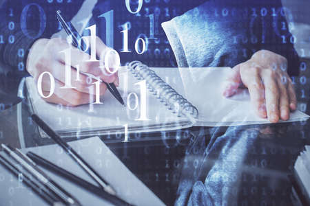 Double exposure of writing hands on background with data solution hologram on front. Technology...