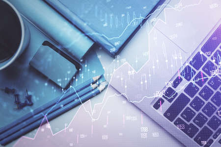 Double exposure of forex graph drawing over desktop background with computer. Concept of financial...