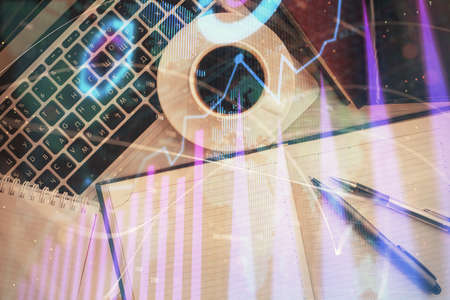 Stock market chart and top view computer on the table background. Double exposure. Concept of...