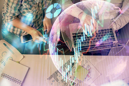 Multi exposure of man and woman working together and forex graph hologram drawing. Financial analysis concept. Computer background. Top View.の写真素材