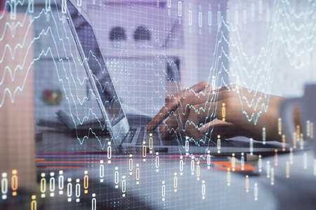 Double exposure of woman hands typing on computer and forex chart hologram drawing. Stock market...