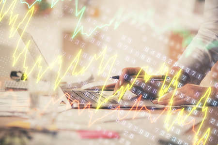 Double exposure of woman hands typing on computer and forex chart hologram drawing. Stock market invest concept.の写真素材