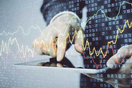 Multi exposure of man's hands holding and using a phone and financial chart drawing. Market analysis...