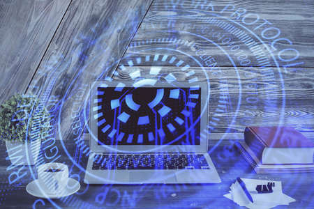 Double exposure of desktop computer and technology theme hologram. Concept of software development.