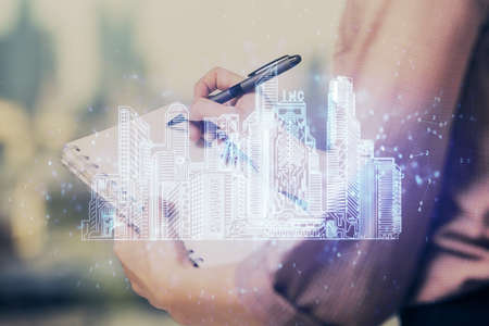 IOT drawing over writing hands in notepad background. Concept of smaert home. Multi exposure